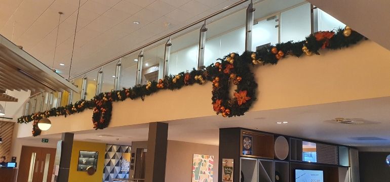 Christmas decorations installed into a corporate work environment, Christmas garlands and wreaths for the festive season